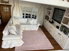 a living room filled with furniture and a flat screen tv on top of a wall