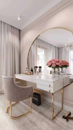 a dressing table with a mirror, chair and flowers on it