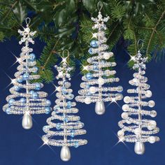 three ornaments hanging from a christmas tree