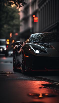 a black sports car is parked on the street