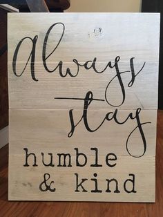 a wooden sign that says, always stay humble and kind on top of a table