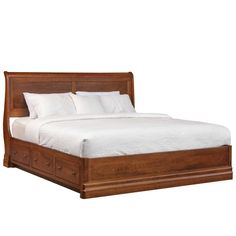 a wooden bed with white sheets and pillows