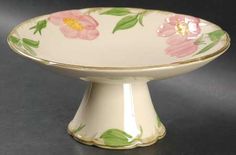 a white bowl with pink flowers painted on it