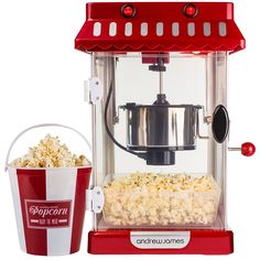 popcorn machine with bucket full of popcorn and bag of popcorn next to it on white background