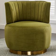 a green chair sitting on top of a rug