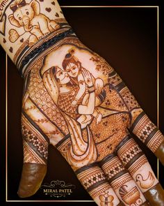 the hand is decorated with henna and an image of a man holding a woman