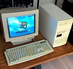 a desktop computer sitting on top of a wooden desk next to a keyboard and mouse