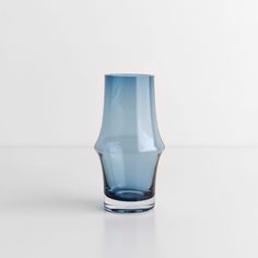 a blue glass sitting on top of a white table