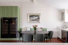 a kitchen and dining room with green cabinets