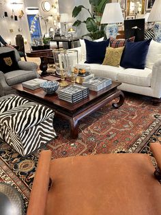 a living room filled with furniture and lots of pillows on top of it's floor