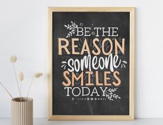 a chalkboard with the words be the reason someone smiles today on it next to a vase