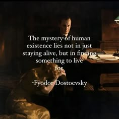 a man sitting at a desk with a dog in his lap and a quote from fyodor dostroevsky