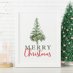 a christmas tree with the words merry christmas in red and green on it next to a white brick wall