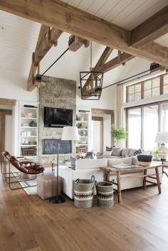 a living room filled with lots of furniture and a flat screen tv mounted to the wall