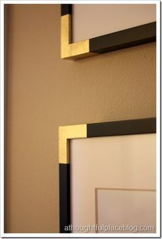 two black and gold framed pictures on the wall