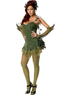 a woman in a green costume is standing with her hands on her hips and looking at the camera