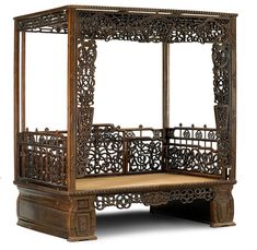 an ornate wooden bed frame with intricate carvings on the top and bottom sides, sitting against a white background