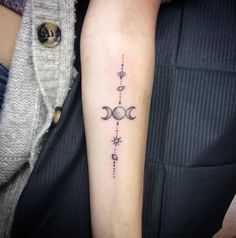 a woman with a tattoo on her arm that has three phases in the same line