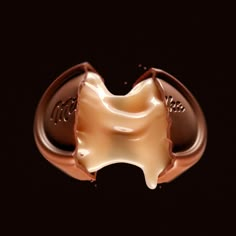 a close up of a chocolate ring on a black background with some liquid in the middle