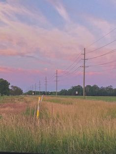 an empty field with power lines in the distance