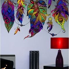 the wall is decorated with colorful feathers on it's sides and has a red lamp next to it