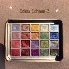 the eyeshadow palette is displayed in front of a wall with text that reads, color scheme 2