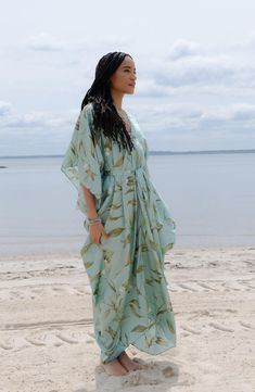 Perfect for poolside hangs or kicking it in the sand, this tie-front kaftan is the perfect accessory to add to your sun-loving wardrobe. V-neck Short sleeves 100% polyester satin Hand wash, line dry Imported Model stats: 5'10", 32" bust, 25" waist, 36" hip. Model is wearing size One Size. Bohemian Tie Waist Cover-up For Beach Season, V-neck Beach Dress With Tie Waist For Vacation, Flowy V-neck Kaftan For Day Out, Breezy Wrap Cover-up For Vacation, Beach Season Cover-up With Tie Waist, Bohemian V-neck Tie Waist Cover-up, Spring Beach Party Cover-up With Tie Waist, Summer Beach Cover-up With Tie Waist, V-neck Summer Kaftan For Vacation