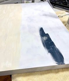 a painting is being painted on top of a table