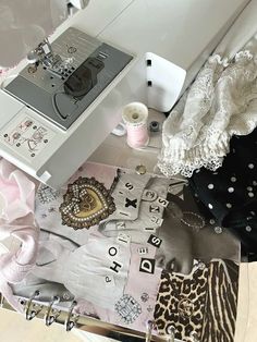 a sewing machine sitting on top of a table next to some fabric and other items