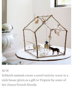 a small house made out of branches with animals in it and the words schleich animals create a novel nativity scene in a sick house as a gift to virginie by some of her close friends