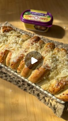 a pan filled with bread sitting on top of a wooden table