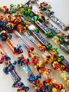 many candy bars are lined up together on the table, including one with an assortment of them