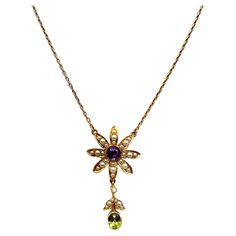 This stunning floral pendant necklace is modern but also classic vintage. The necklace is from the early 1900's and replicates a beautiful flower with petals adorned in tiny seed pearls. The center is a round faceted amethyst and the bottom petal has a drop of seed pearls accenting an oval faceted peridot. The necklace is 16 inches long so it rests beautifully on your collarbone. Gorgeous! Luxury Victorian Flower Pendant Necklace, Luxury Antique Flower Pendant Necklace, Vintage Flower-shaped Gemstone Jewelry, Vintage Flower Gemstone Jewelry, Heirloom Formal Necklace With Flower Pendant, Heirloom Style Formal Necklace With Flower Pendant, Heirloom Flower Pendant Necklace For Formal Occasions, Antique Hallmarked Flower Pendant Necklace, Ornate Flower Pendant Necklace For Formal Occasions