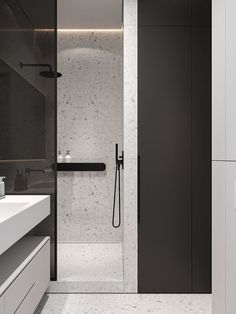 a modern bathroom with black and white fixtures, marble flooring and walls in the shower area