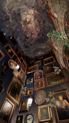 the ceiling is covered with many paintings and pictures