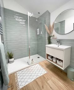 a bathroom with a shower, sink and mirror