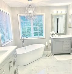 a bathroom with a tub, sink, and mirror in it's center area