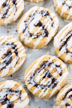 chocolate chip cinnamon rolls with icing on a baking sheet