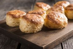 some biscuits are sitting on a wooden board