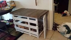 a small wooden table sitting next to a doorway