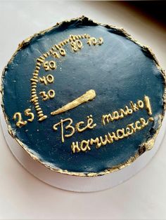 a blue cake with gold writing on it