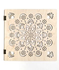 a wooden block with an intricate design on the front and sides, cut out from plywood