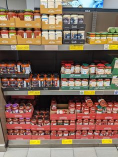 the shelves are filled with various types of food and condiments for sale in a grocery store