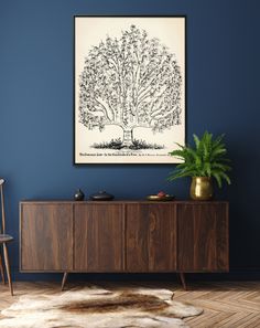 a room with blue walls and a large tree on the wall above a wooden cabinet