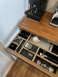 a coffee maker is sitting on top of a wooden shelf next to a cup holder