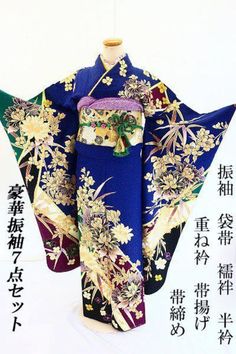 This furisode (long-sleeved kimono) is made of silver-transparent dark blue silk with green and black blossom colors and auspicious flowers such as peonies, cherrys, and bamboo grass, etc., painted in gold. The peonies are embroidered with gold and lame threads. Contents of set Furisode (long-sleeved kimono) Long underwear Obi (sash) Obiage Obijime Kasane Collar Half Collar Kimono Furisode: Height (from the shoulder): approx. 167.0 cm (height cannot be taken out), lintel: 119.5 cm. Sleeve length of kimono: approx. 108.0 cm, lintel 109.0 cm Length from kimono sleeve to kimono sleeve: approx. 67.0 cm (impossible to make out the length from the kimono sleeve). 65.0 cm from kimono sleeve to kimono sleeve. Front width of kimono: approx. 24.0 cm / Rear width: approx. 28.0 cm Obi (sash) Width: ap Black Blossom, Obi Sash, Bamboo Grass, Long Sleeve Kimono, Silk Peonies, Luxurious Wedding, Japanese Patterns, Kimono Sleeve, Blue Silk