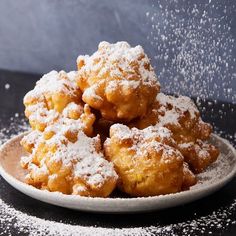 powdered sugar sprinkles are falling from a plate on a table top