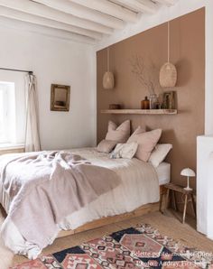 a bed sitting in a bedroom next to a window