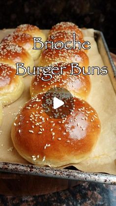 bread buns with sesame seeds on top in a baking pan