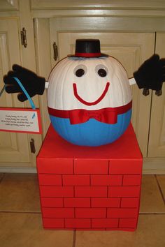 a large pumpkin sitting on top of a red block